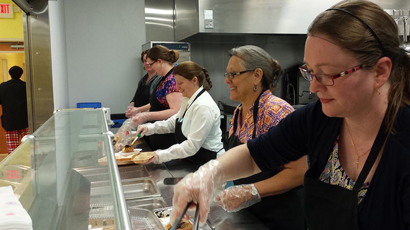 A group of volunteers handing out food.